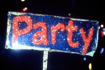 This image showcases a glittery sign with the word 'Party' written in bold, red letters against a sparkly blue background. It emits a vibrant and celebratory vibe, perfect for events.