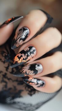 Stunning nails showcase bats against a black and orange backdrop for Halloween