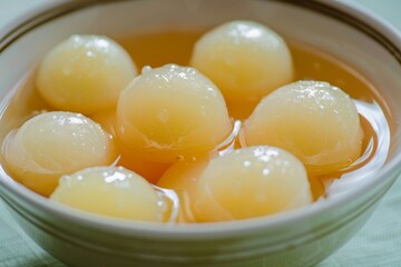 Roshogolla: Soft and spongy roshogollas floating in sugar syrup, displayed in a dessert bowl