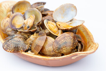 Close up of a Clams in marinera sauce appetizer on white background, a typical appetizer from Galicia, Spain