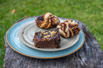 Chocolate breads like a brownie on a blue plate in daylight as breakfast