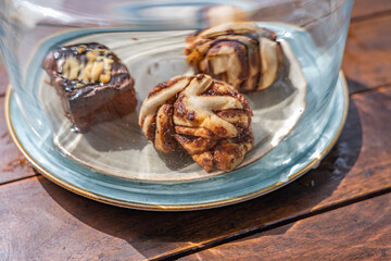 Chocolate breads like a brownie on a blue plate in daylight as breakfast