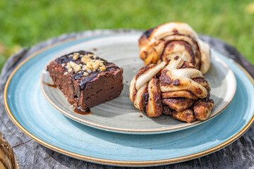 Chocolate breads like a brownie on a blue plate in daylight as breakfast