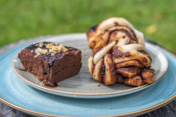 Chocolate breads like a brownie on a blue plate in daylight as breakfast