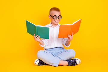 Photo of diligent intelligent cheerful funny boy wear white shirt sit floor read book isolated on...