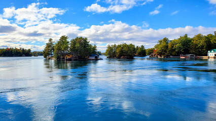 Serene landscape of the Thousand Islands along the Canada USA border with beautiful reflections