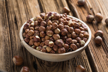 Full and peeled hazelnuts close-up. Macro photo of pile of filbert kernels