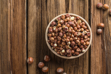 Full and peeled hazelnuts close-up. Macro photo of pile of filbert kernels