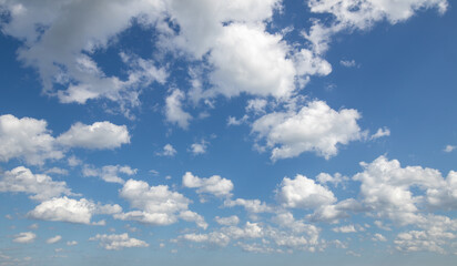 Sky replacement blue fluffy clouds over horizon against vivid blue sky