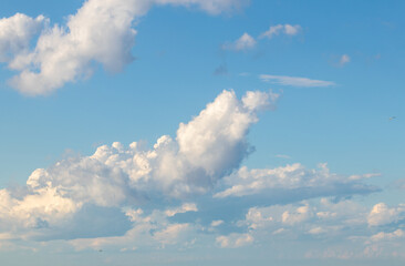 Sky replacement puffy clouds rolling in against aqua sky