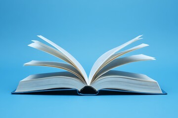 Fototapeta premium A minimalistic stock photo of an open book with pages turning, isolated against a blue background