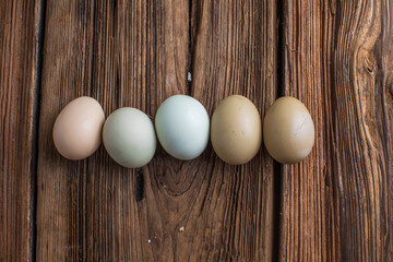 Brown, green eggs on wooden table.  Chicken, Hen eggs