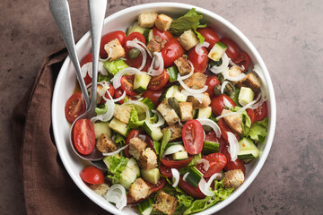Tuscan Panzanella, traditional Italian salad with tomatoes and bread. Vegetarian panzanella salad. Mediterranean healthy food.