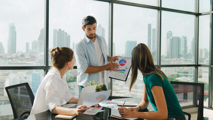 Professional businessman present financial graph to smart investor. Skilled executive manager shows business statistic while business team working together, brainstorming, sharing idea. Tracery