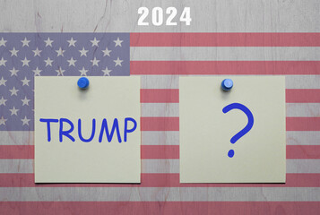 Two sheets of paper with the words Trump and a question mark written on them