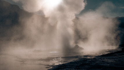smoke coming out of the land of geysers at sunrise