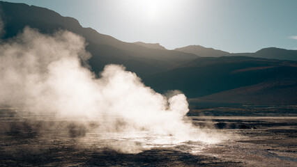 smoke coming out of the land of geysers at sunrise