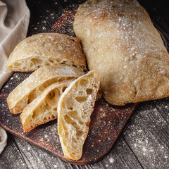 Ciabatta Italian bread with Olive Oil: Fresh, Rustic, Homemade, and Delicious on a Wooden Table