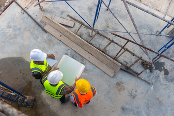 Top view of architects engineer are discussing about the progress of construction building plan.