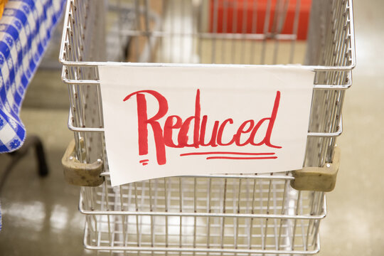 shopping cart with sign that says reduced