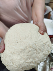 Baker kneading dough on table