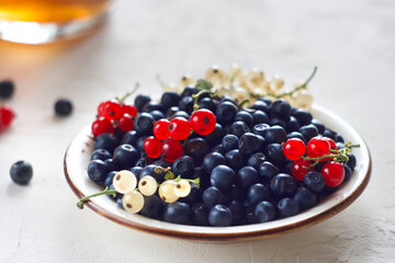 Blueberries and lingonberries in a plate on the table