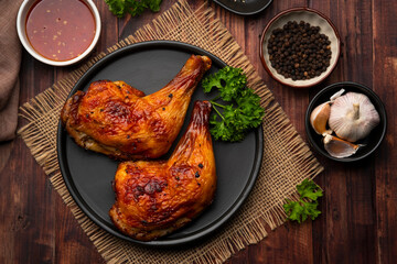 Air Fryer grilled chicken on black plate,served with chilli sauce.Top view