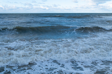 Surf on the Baltic Sea coast. Wave on a sandy beach.