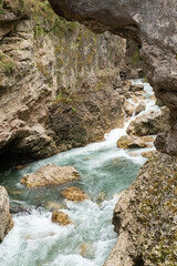 A stormy mountain river flowing in a narrow rocky gorge