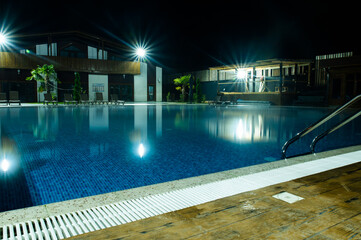 Night lighting of the pool in a small mountain hotel