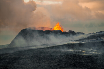 volcano in Grindavik erupting and lava magma flowing to the hills of iceland