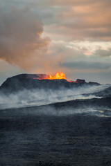 Fototapeta premium volcano in Grindavik erupting and lava magma flowing to the hills of iceland