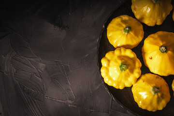 Autumn and summer vegetables and mushrooms on a black background and a canvas napkin. Yellow...