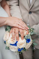 Bride and groom posing together with a beautiful bouquet, showcasing their love on their wedding...