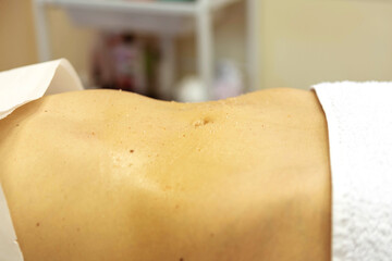 Flat tummy ready for a massage in the massage room  