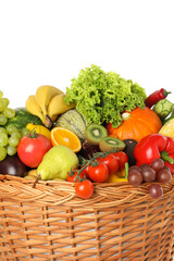 Different fresh fruits and vegetables in wicker basket isolated on white