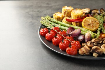 Delicious grilled vegetables on grey table, closeup. Space for text