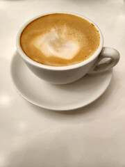 White cup with hot coffee. Cup of coffee on white background