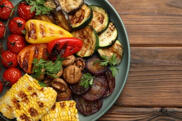 Delicious grilled vegetables on wooden table, top view