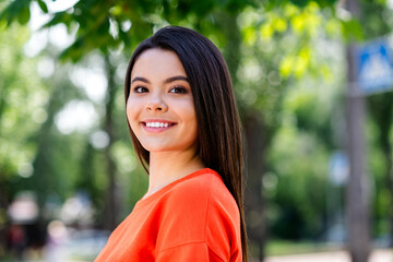 Photo of attractive teen cheerful girl cheerful smile wear red garment having fun outside outdoors