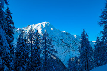 Panoramic view of snow capped mountain peaks of Karawanks mountain range in Bärental valley,...