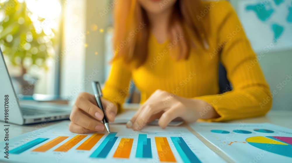 Poster woman analyzing data and creating report with colorful charts and graphs at work desk. business and 