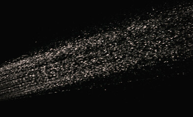 Splashes of water pouring from a hose in the dark