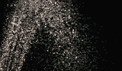 Splashes of water pouring from a hose in the dark