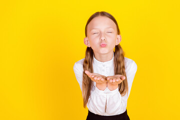 Photo portrait of charming little pupil girl send you air kiss closed eyes wear trendy uniform...