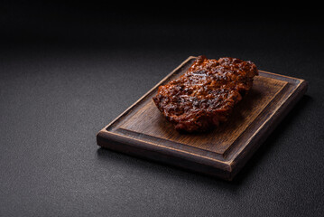 Fresh juicy delicious beef steak on a dark background