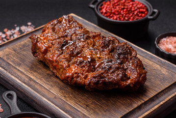 Fresh juicy delicious beef steak on a dark background