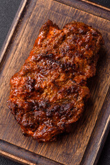 Fresh juicy delicious beef steak on a dark background
