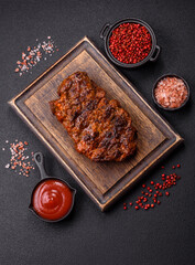 Fresh juicy delicious beef steak on a dark background