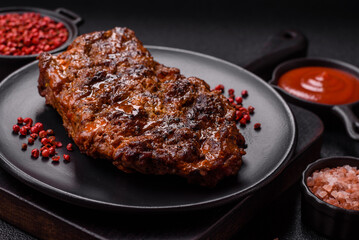 Fresh juicy delicious beef steak on a dark background